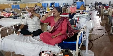 COVID19 patients take part in yoga and meditation sessions at Sardar Patel COVID Care Centre in New Delhi. (Photo| ANI)