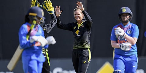 Australia's Jess Jonassen (C) is congratulated by teammates after taking her fifth wicket in the final of their women's T20I match vs India in Melbourne. (File photo| AFP)