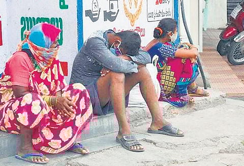 Relatives of Covid patients wait outside a hospital in Karimnagar, on Sunday