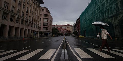 A Sri Lankan man wearing a protective mask crosses a deserted road during a lockdown imposed to curb the spread of the coronavirus in Colombo, Sri Lanka, Saturday, May 15, 2021. (Photo | AP)