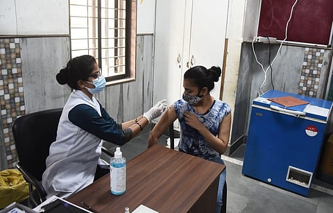 A beneficiary above 18 years old gets the COVID-19 vaccine, at a government school in New Delhi on Tuesday. (Photo | Parveen Negi, EPS)