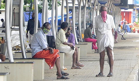 Homeless people waiting at the East Fort bus terminal for free food being distributed by the NGOs. A scene on day one of the triple lockdown. (Photo | B P Deepu, EPS)