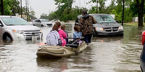 Parents use boats to pick up students from schools after nearly a foot of rain fell in Lake Charles. (Photo | AP)