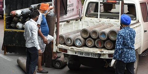 ikh volunteers unload oxygen cylinders to support COVID-19 patients for free, at a gurudwara in Indirapuram, Ghaziabad. (Photo | PTI)