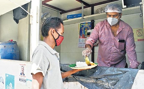 A man receiving his food at an Annapurna canteen, as the GHMC announced it will supply free food. (Photo | S Senbagapandiyan, EPS)