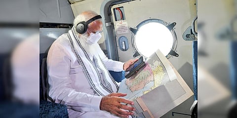 PM Narendra Modi conducts an aerial survey of cyclone Takutae-hit Gujarat. (Photo| PIB in Gujarat)