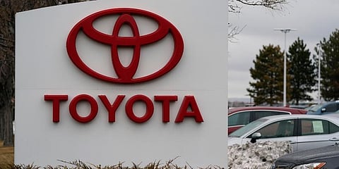 The company logo adorns a sign outside a Toyota dealership Sunday, March 21, 2021, in Lakewood, Colo.