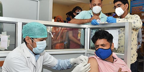 A medic inoculates the dose of the COVID-19 vaccine to a beneficiary, in Bikaner. (Photo | ANI)