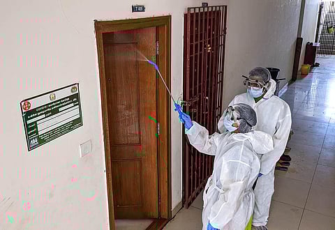 Corporation workers santizing an apartment at Ayanambakkam in Chennai. (Photo | Debadatta Mallick, EPS)