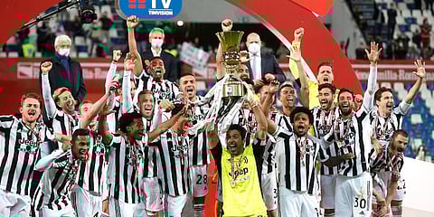 Juventus players celebrate with the winner's trophy their victory against Atalanta after the end of Italian Cup soccer final match at the Mapei Stadium in Reggio Emilia. (Photo | AP)