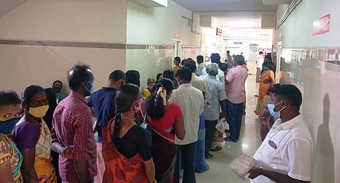 Patients and attenders stand in a queue without caring for social distancing norms, personal safety at Govt Tiruvannamalai Medical College Hospital. (Photo | Special Arrangement)