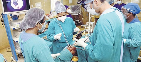 Doctors treat a patient infected with black fungus. (Photo | PTI)