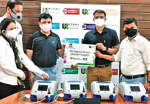 Utkal Hospital CFO Arun Khillar receives the ventilators from TCS Regional HR head KP Tripathy and another TCS official Bimal Kumar Roul. (Photo| EPS)