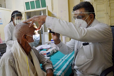 Dr. Pervez Siddiqui attends to a patient infected with mucormycosis at NSCB Medical College and Hospital in Jabalpur. (Photo | PTI)
