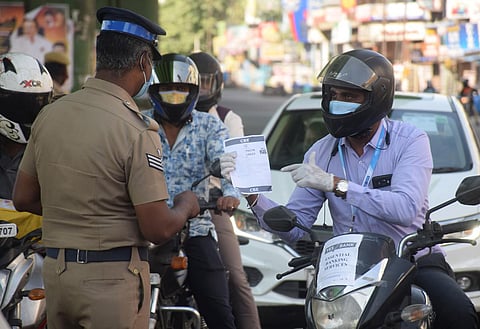 Police check for the e-pass due to the complete lockdown in Coimbatore City on Monday. (Photo | U Rakesh Kumar, EPS)