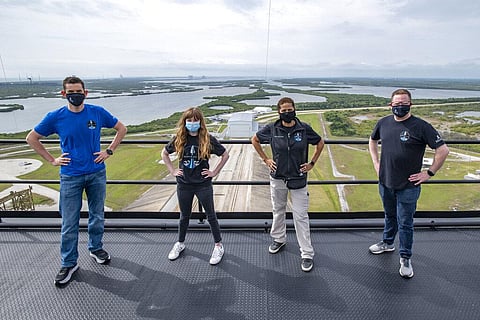 Jared Isaacman, Hayley Arceneaux, Sian Proctor and Chris Sembroski pose for a photo on the SpaceX launch tower at NASA's Kennedy Space Center at Cape Canaveral. (Photo | AP)
