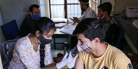 A medic administers a dose of COVID-19 vaccine at a vaccination centre in Mathura. (Photo | PTI)
