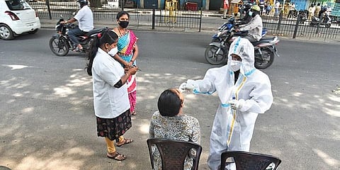 Health workers collect swab samples from motorists in Bengaluru on Tuesday | Vinod Kumar T