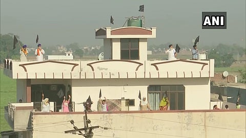 People put up black flags at their houses in Amritsar as the farmers protesting against the Farm Laws, observe 'Black Day'.