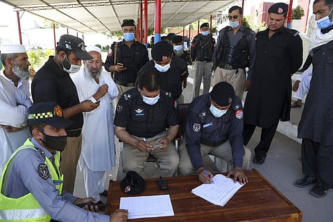 Police officers register to receive their first shot of the Sinopharm coronavirus vaccine, at a vaccination center in the police headquarters, in Peshawar. (Photo | AP)