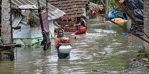 A woman wades through a water-logged road in a village after landfall of cyclone Yaas, in South 24 Paragnas. (Photo | PTI)