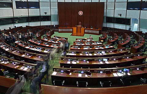 Pro-China lawmakers leave the chamber after the 'Improving Electoral System (Consolidated Amendments) Bill 2021' was passed, at the Legislative Council in Hong Kong. (Photo | AP)