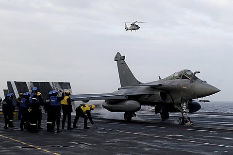 Staff look at a Rafale jet fighter about to take off the French aircraft carrier Charles de Gaulle at sea, off the coast of the city of Hyeres (Photo | AP)