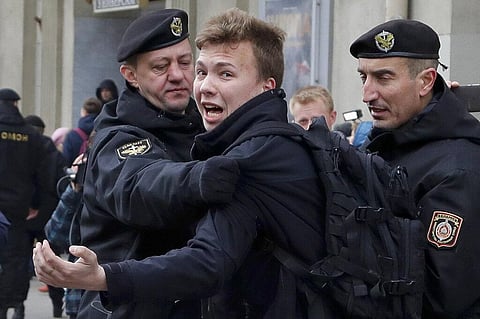 In this March 26, 2017, file photo, police detain journalist Roman Pratasevich, center, in Minsk, Belarus. (Photo | AP)