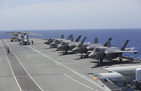 Military personnel inspect US and British jets as they participate in the NATO Steadfast Defender 2021 exercise on board the aircraft carrier HMS Queen Elizabeth off the coast of Portugal. (Photo | AP