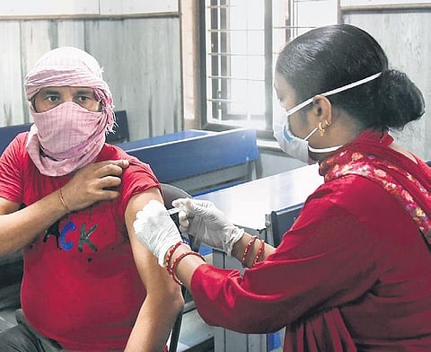 A beneficiary gets the vaccine at a govt school in New Delhi on Friday | PARVEEN NEGI