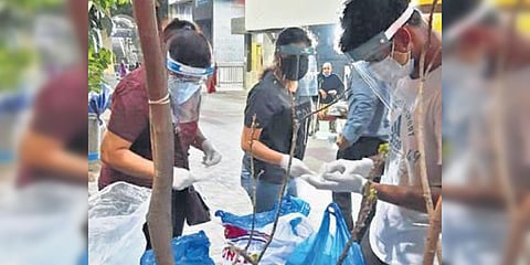 Youngsters distributing food to the needy in Hyderabad. (Photo| EPS)
