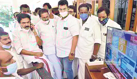 KC(M) chairman Jose K Mani watches the live election updates on television along with a group of party workers at his residence in Pala on Sunday | Express