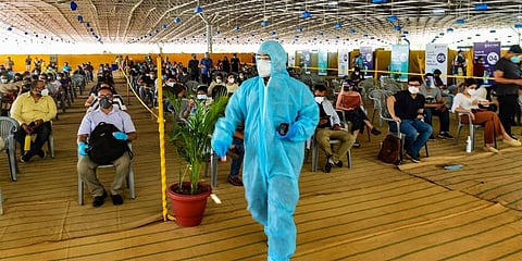 People over 18 years of age wait to receive COVID-19 vaccine doses, at one of the largest vaccination sites set up by BLK-Max hospital in New Delhi, Tuesday. (Photo | PTI)
