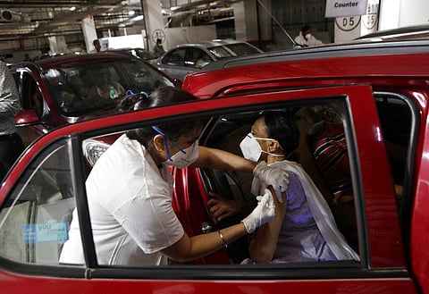 A woman receives a vaccine for COVID-19 in her car at a drive-in vaccination centre in Mumbai, India, Tuesday, May 4, 2021. (Photo | AP)