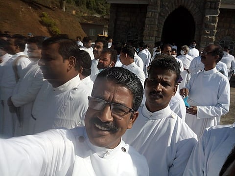 Priests at the retreat without facemasks and not maintaining social distancing.