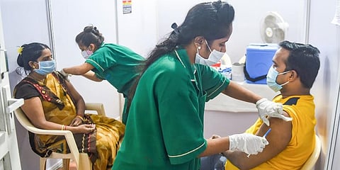 Health workers administer COVID-19 vaccine doses to beneficiaries, at the Jumbo COVID Vaccination Centre, in Mumbai. (Photo | PTI)