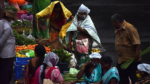 People take cover from the rains.