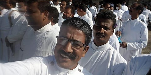 Priests at the retreat without facemasks and not maintaining social distancing.
