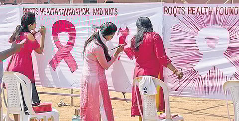 Students and citizens painting an 1800-feet-long cloth to spread awareness on breast cancer. (File Photo| EPS)