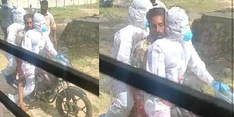 Two volunteers at the care centre taking a patinet to hospital on a bike. (Facebook Photo)