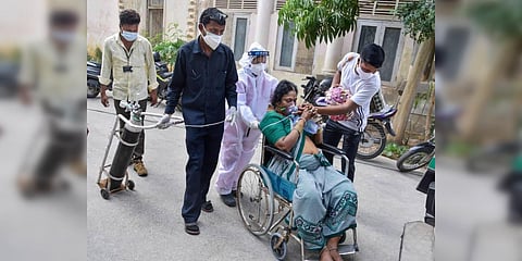 A COVID-19 patient returns back due to non-availability of beds at a hospital, in Hyderabad. (File photo| PTI)
