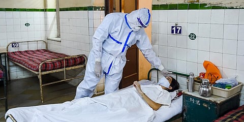 Gynaecologist Amol Pawar, wearing PPE kit, attends a patient in the Covid-19 ward of Nowrosjee Wadia Maternity Hospital, in Mumbai, Wednesday, May 5, 2021. (Photo | PTI)