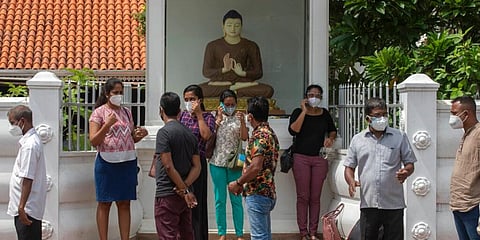 Sri Lankans wait to give swab samples to test for COVID-19 by a roadside in Colombo, Sri Lanka. (Photo | AP)