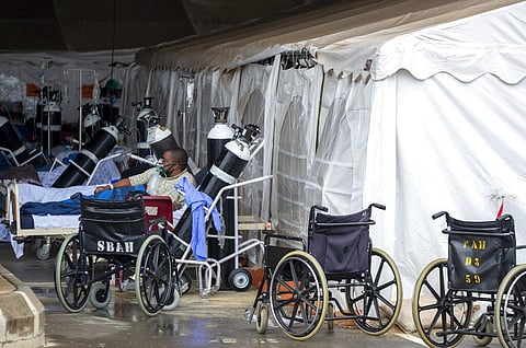 a patient wearing an oxygen mask is treated in a makeshift emergency unit at Steve Biko Academic Hospital in Pretoria, South Africa. (Photo | AP)