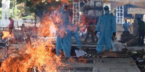 Cremation of COVID-19 victims at Nigambodh Ghat cremation ground as coronavirus cases surge in New Delhi. (Photo | PTI)