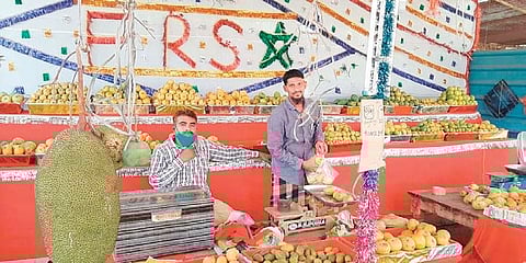 Traders sell mangoes at the Fruit Research Station in Sangareddy town