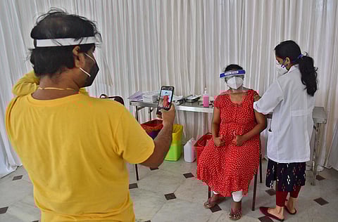 A medic administering a COVID-19 vaccine to a beneficiary during a mass vaccination drive by a private hospital at a Convention Hall in Bengaluru. (Photo | Ashishkrishna HP, EPS)