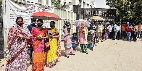 Beneficiaries wait in a queue to receive the COVID-19 vaccine dose, at a vaccination camp at DAV School Sector 49, in Gurugram. (Photo | PTI)