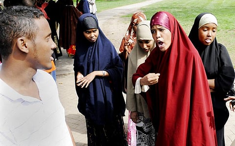 Fardowsa Anshur, right, voices her anger after they received the news that JBS Swift & Co would not accommodate the Muslim employees with a sunset break for prayer. (Photo | AP)