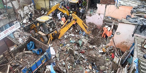 Rescue operation underway after a single-storey house collapsed on another structure in Malwani area on Wednesday night, in Mumbai (Photo | PTI)